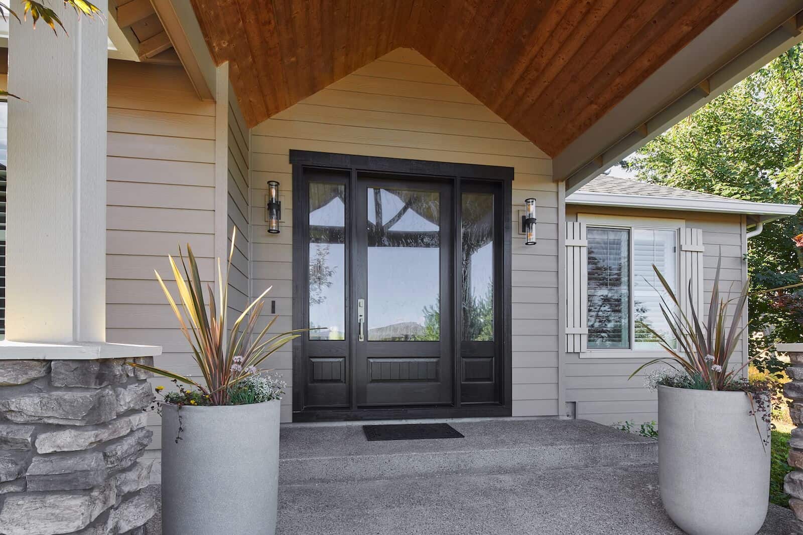 remodeled exterior entry with black door.
